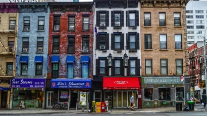 Multicolored four-story New York City buildings with storefronts on ground floor