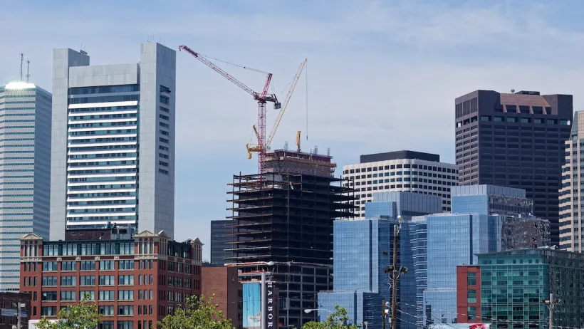 Buildings in downtown Boston with large red construction crane.