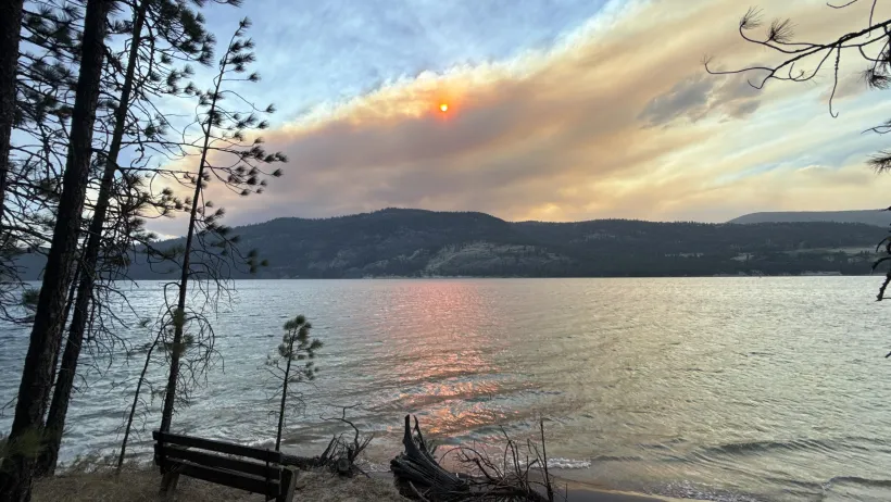 Wildfire smoke from the Kaiser Canyon and Modrite fires on the Colville Reservation drifts across the sky over Lake Roosevelt, casting an orange glow on the water as eastern Washington wildfires burn over 250,000 acres across the region