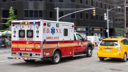Ambulance driving down New York City street
