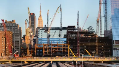 New York City skyline with construction cranes in foreground