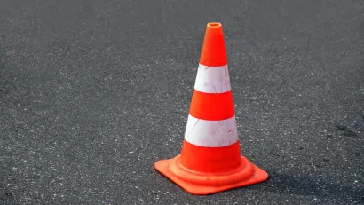 Orange traffic cone on black asphalt