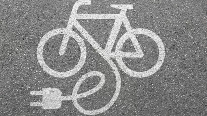 White electric bike logo on asphalt