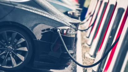 Close-up of line of cars at electric vehicle charging station