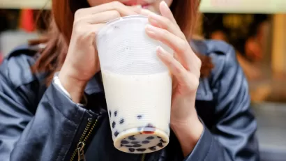 Close-up of woman drinking boba bubble tea through straw