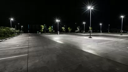 Asphalt parking lot at night with bright lights