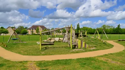 Children's playground in a London park with a green lawn