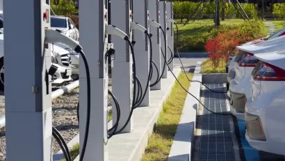 Electric vehicle charging station with white cars plugged in