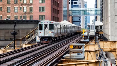 CHicago elevated train passing by brick buildings