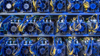 Wall of computer servers with blue and yellow cables for cryptocurrency mining