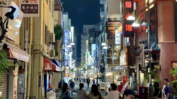 Uenookachimachi Central Street in Taitō City, Tokyo, a lively pedestrian-friendly street known for its neon glow, narrow storefronts, and energetic nighttime vibe.