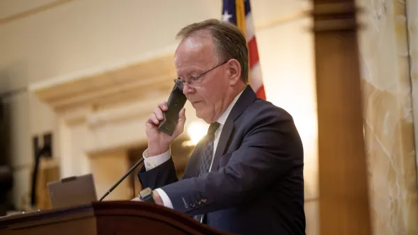 A man on the phone in the Utah senate