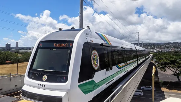 A white train on a raised rail line