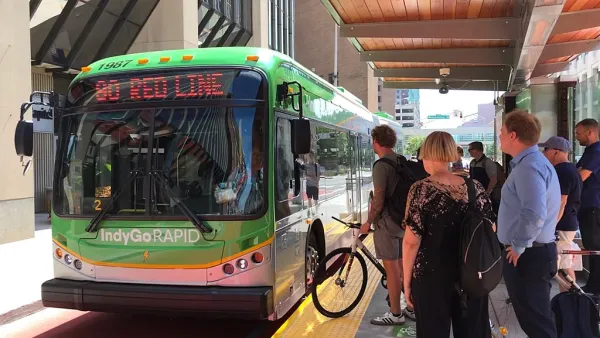 Passengers line up to board a bus at a bus rapid transit station in Indianapolis.