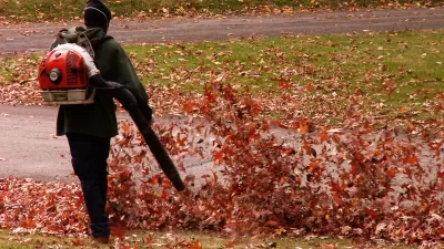 A groundskeeper blows autumn leaves in the Homewood Cemetery, Pittsburgh
