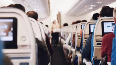 Airplane aisle with seated passengers