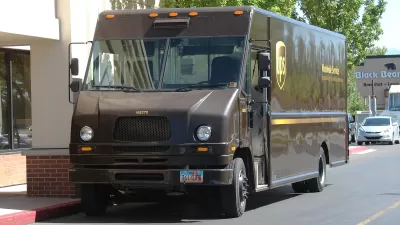 UPS delivery truck parked by urban sidewalk