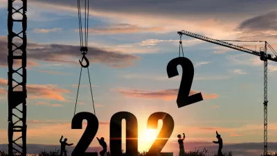 A silhouette of construction workers lowering larger numerals into place to form 2022.