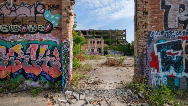 Ruined brick walls with graffiti on them stand as part of partically demolished building in Clevelannd, Ohio.