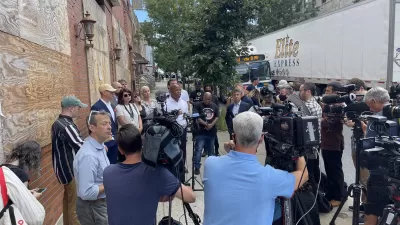 A large group of press and media surround New York City mayoral candidate Eric Adams.