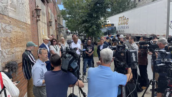 A large group of press and media surround New York City mayoral candidate Eric Adams. 