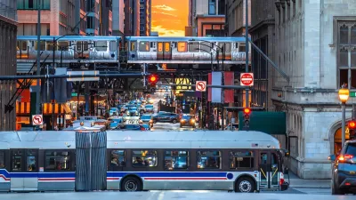 White CTA bus and elevated train against sunset sky in downtown Chicago, Illinois.
