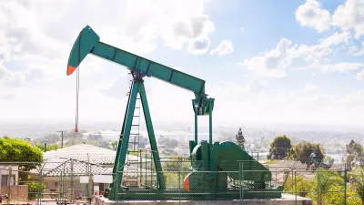 Green oil well in California neighborhood.