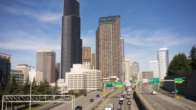View of Interstate 5 with light traffic and downtown Seattle skyline in background