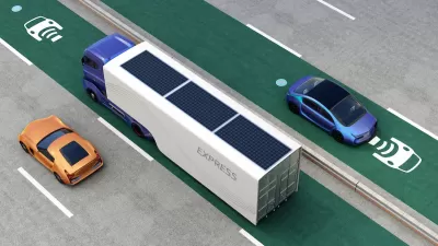 Rendering of truck and cars driving on green electric vehicle charging roadway lane.