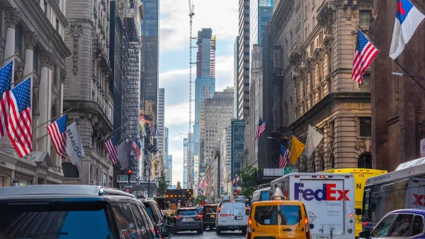 Traffic jam on 5th Avenue in Manhattan, New York City with One World Trade Center tower under construction visible in background.
