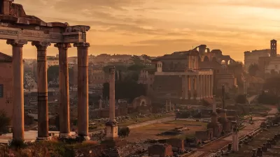 Roman Forum ruins in Rome, Italy with dusk sky.
