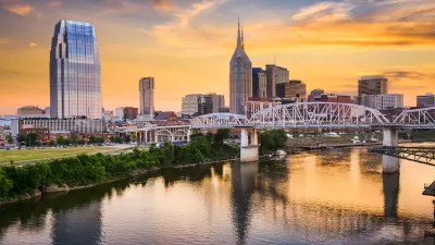 Sunset view of downtown Nashville, Tennessee skyline from across a river.