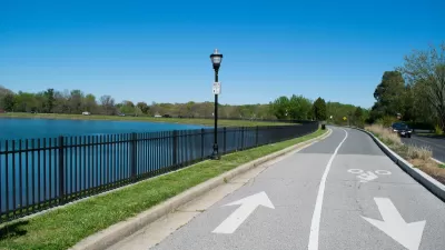Bi-directional bike trail next to small lake in Baltimore, Maryland.