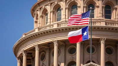 US and Texas flags flying in front of Texas state capitol dome in Austin, Texas.