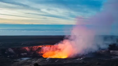 Lava visible in crater with steam coming out in Hawaii.