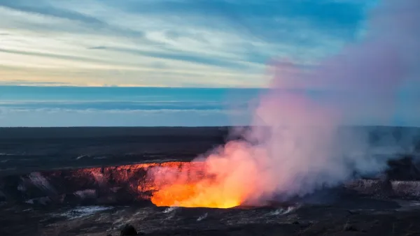 Lava visible in crater with steam coming out in Hawaii.