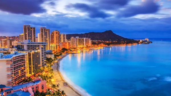 Aerial view of Honolulu, Hawaii coastline at dusk.