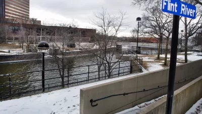 Flint River with blue sign on post in winter.