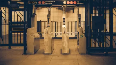 Sepia-toned photo of New York City subway turnstiles.