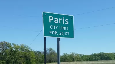 Green Paris Texas city limit sign with population.