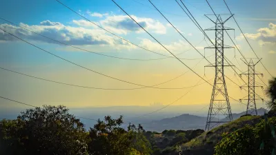 Power lines at golden hour with downtown Los Angeles in far background.