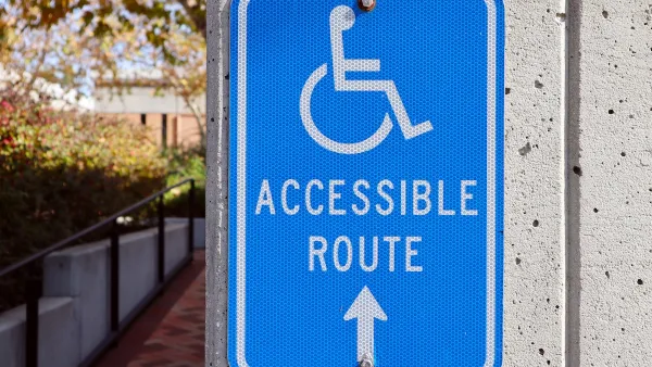 Blue and white "Accessible Route" sign with wheelchair logo.