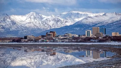 Anchorage, Alaska skyline with snowy mountains in background.