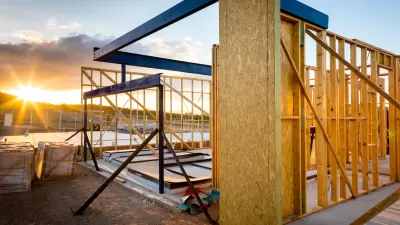Square wood-frame home under construction.