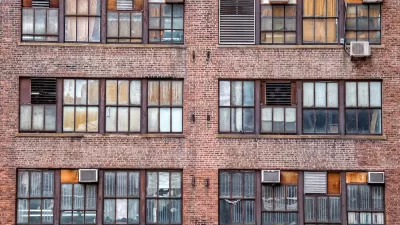 Manhattan brick apartments with AC units on windows.