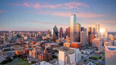 View of downtown Dallas, Texas skyline with skyscrapers against twilight sky.