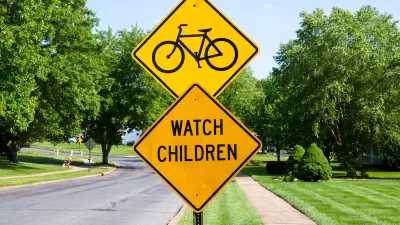 Yellow street sign with bike symbol above yellow 'Watch Children' sign.