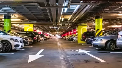 Interior of large parking garage full of cars.