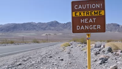 'Caution Extreme Heat Danger' sign in Death Valley, California with desert mountains in background