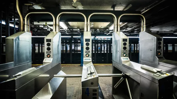 Silver turnstiles at a subterranean subway station